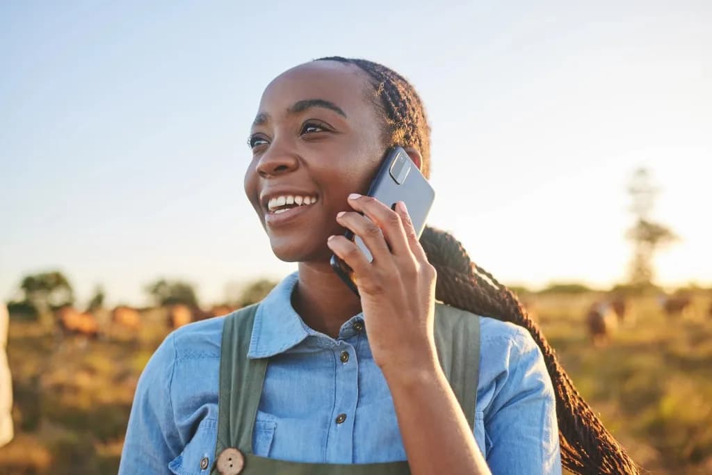 A woman making a phone call in a rural setting