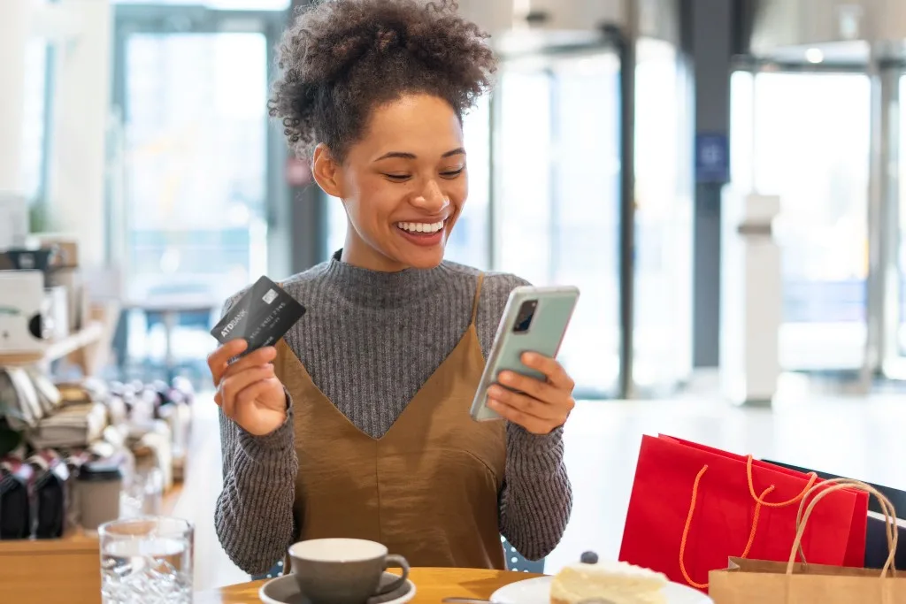 A customer paying with her bank card and phone