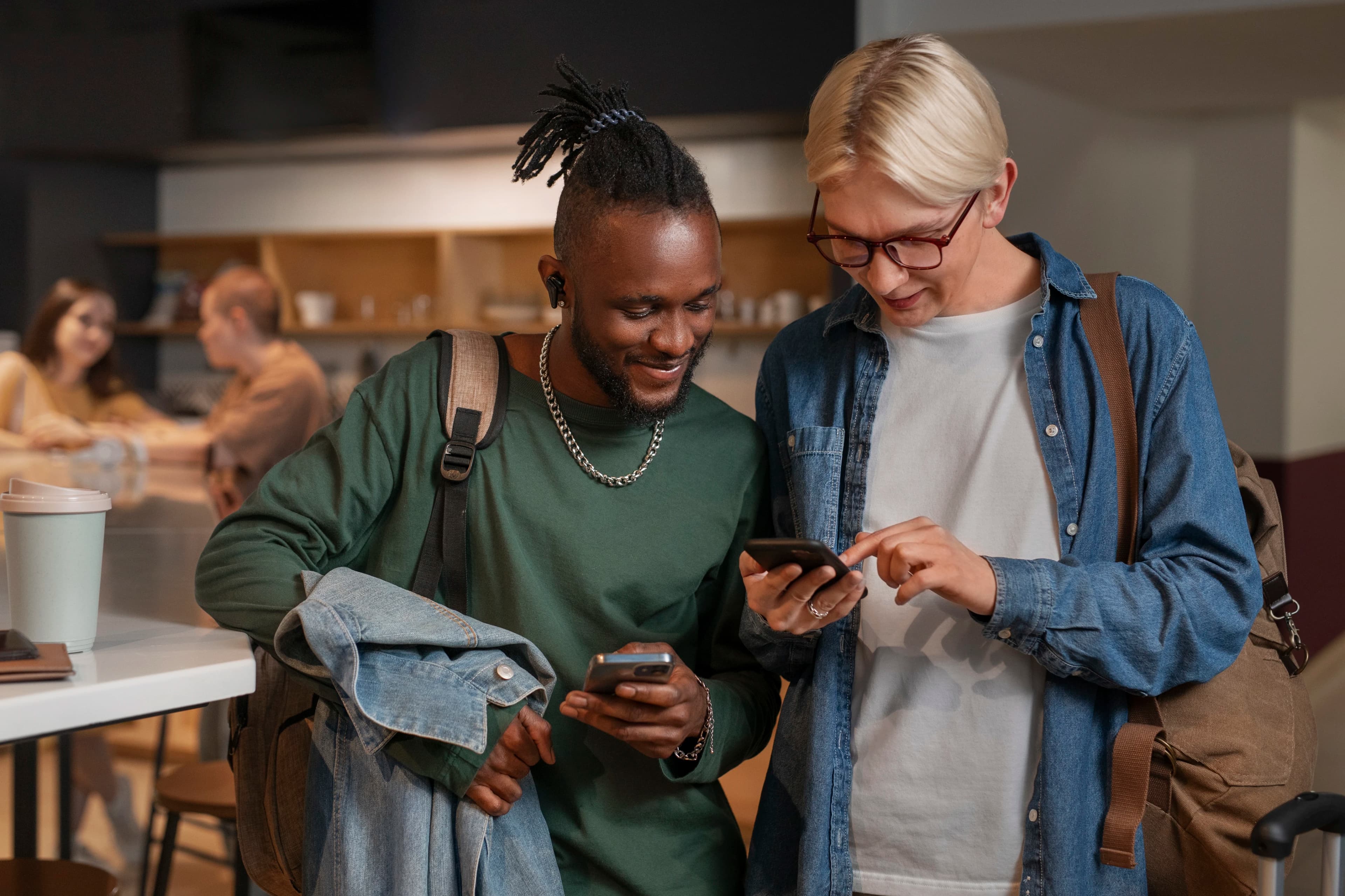 Two subscribers comparing phones together in a cafe
