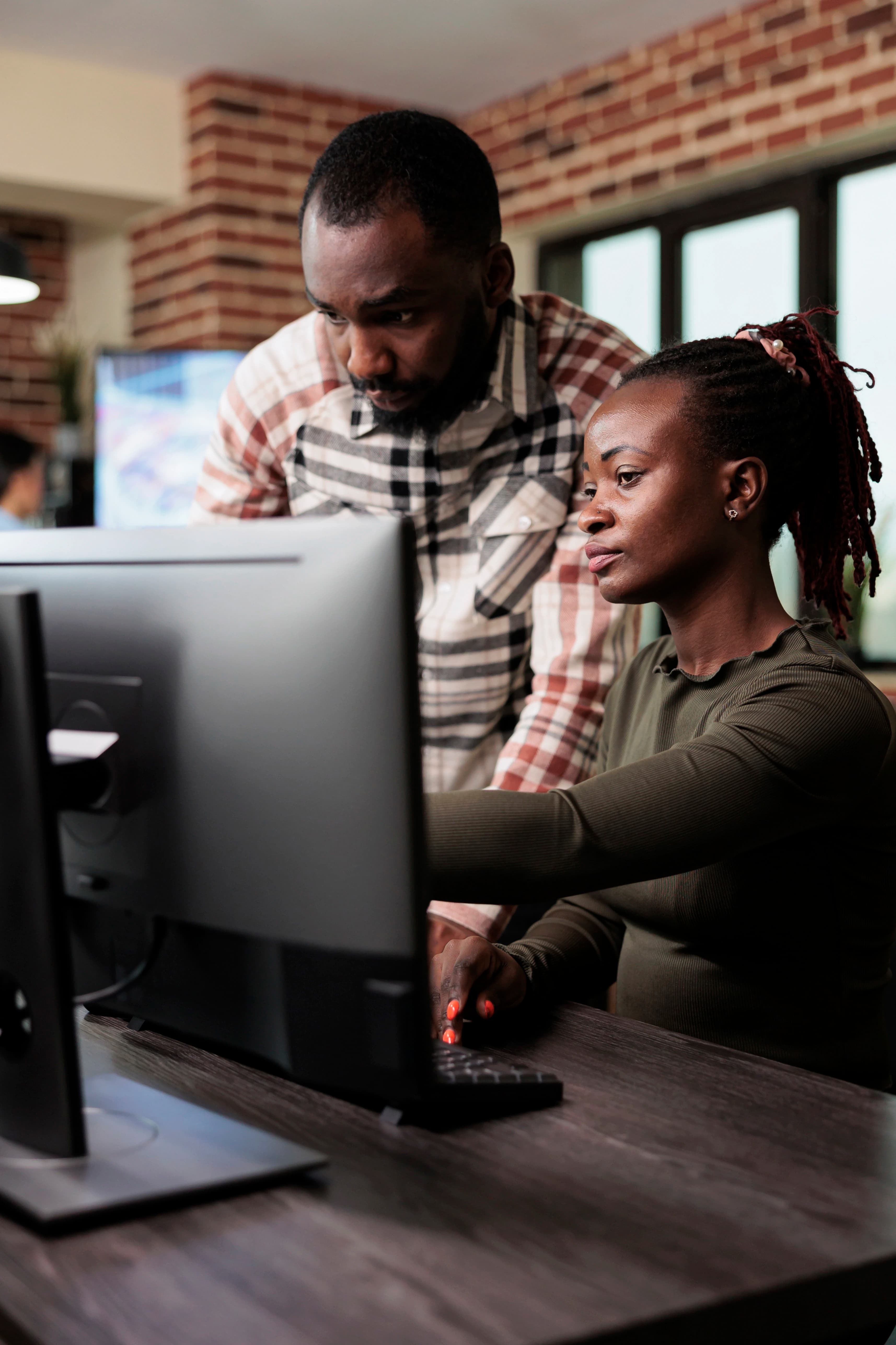 A support team assisting subscribers at a workstation