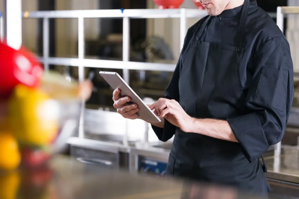 A retailer using a tablet to manage inventory